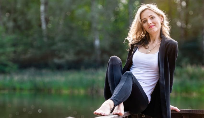 A woman sitting on a railing.