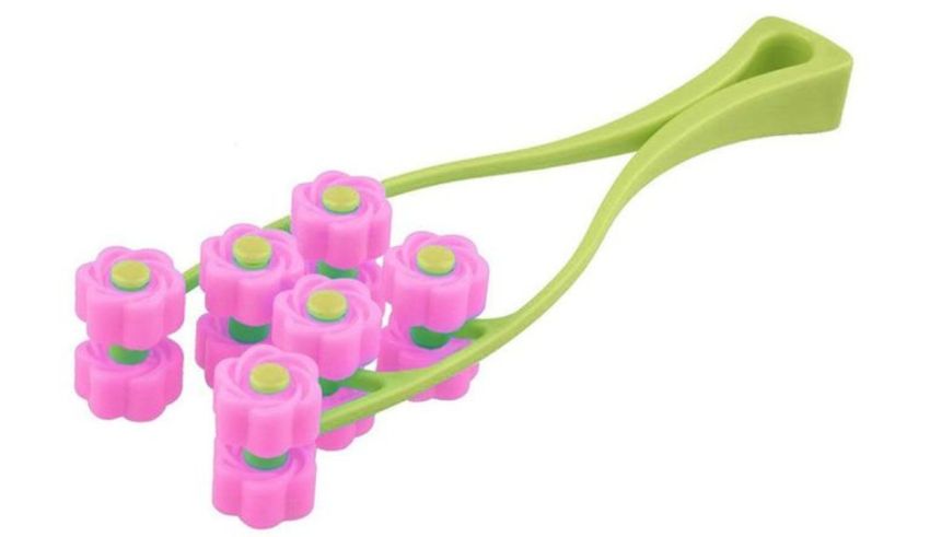 A pink and green toothbrush with flowers on it.