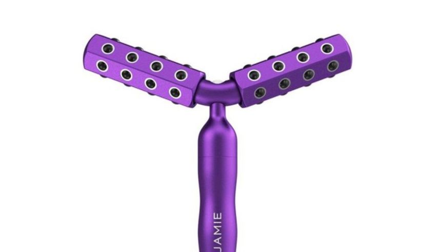 A purple hair comb with holes on it.