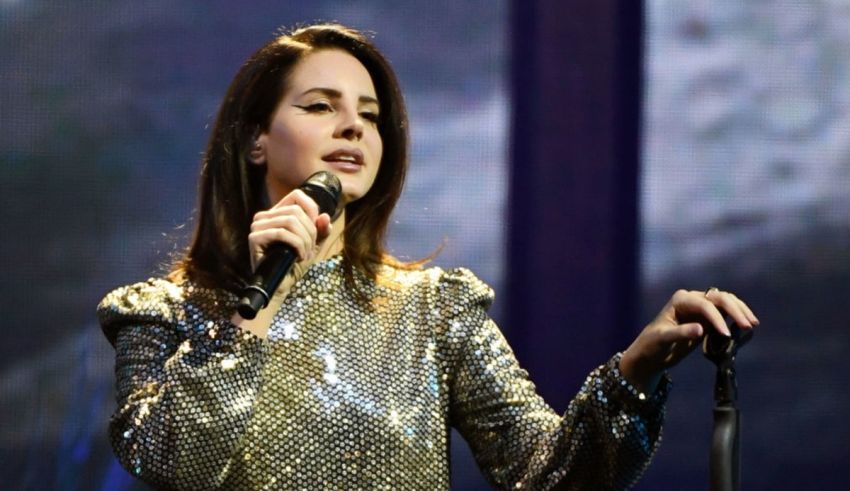 A woman in a silver dress singing into a microphone.