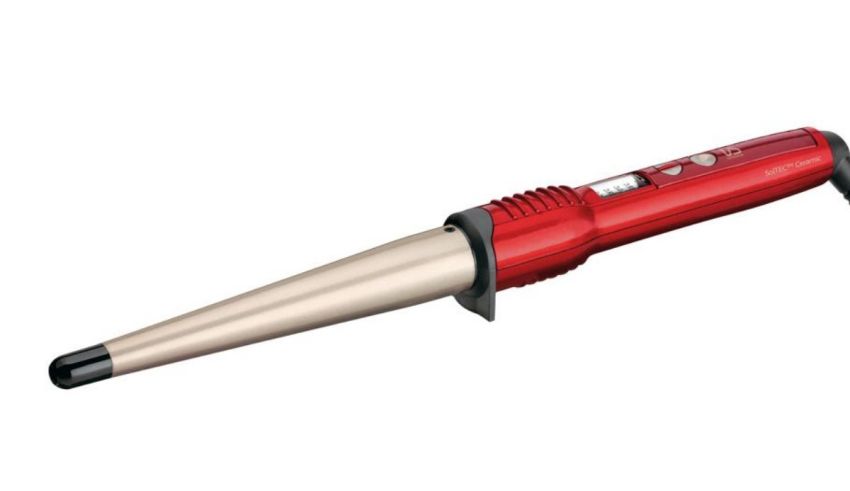 A red and black hair curler on a white background.