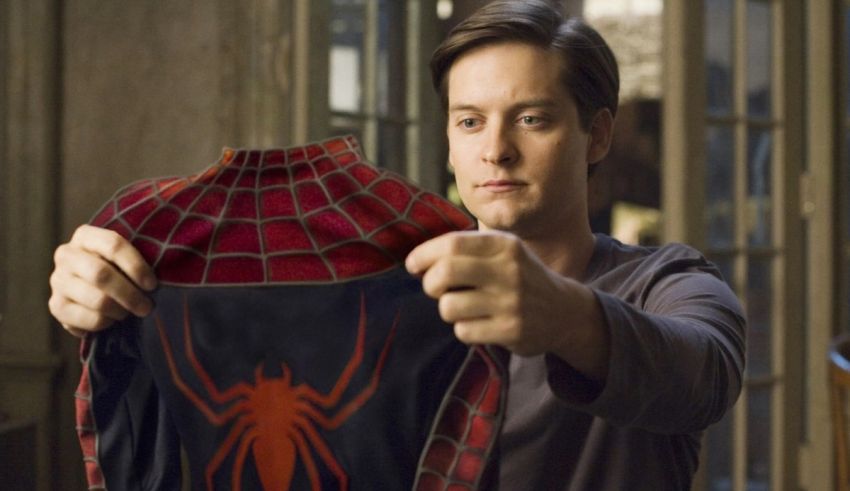 A man holding up a spider - man costume.