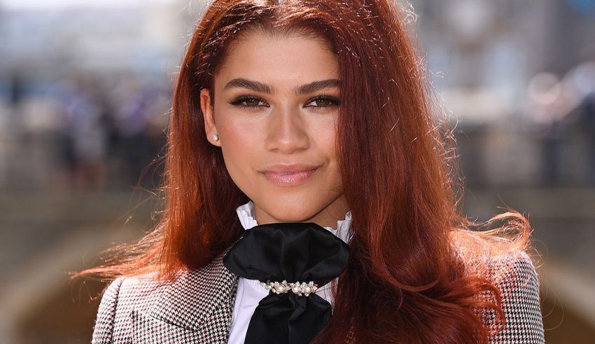 A woman with red hair is posing for a photo.