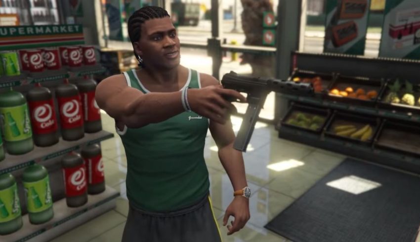 A man in a green shirt is holding a gun in front of a store.