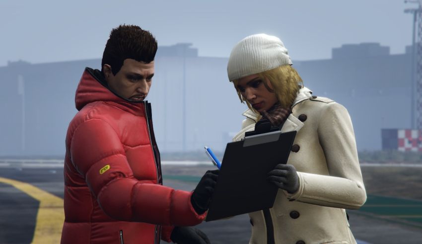 A man and woman are looking at a clipboard.