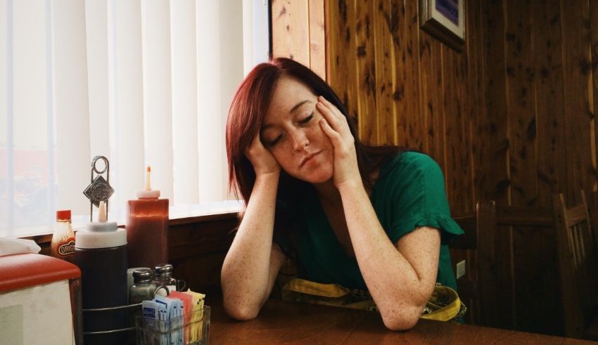 A woman sitting at a table in a diner.