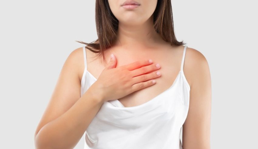A woman with a chest pain holding her hand.