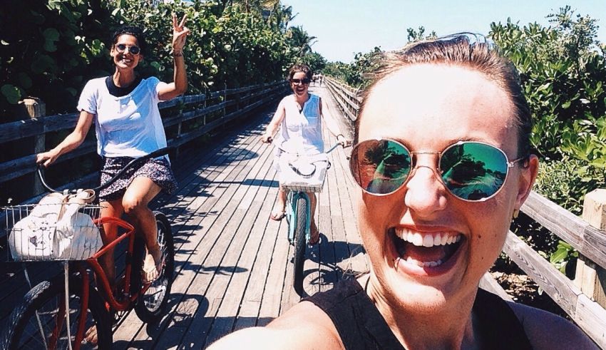 A group of women riding bikes on a wooden boardwalk.