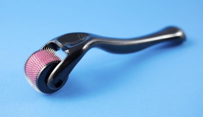 A black brush with pink bristles on a blue background.