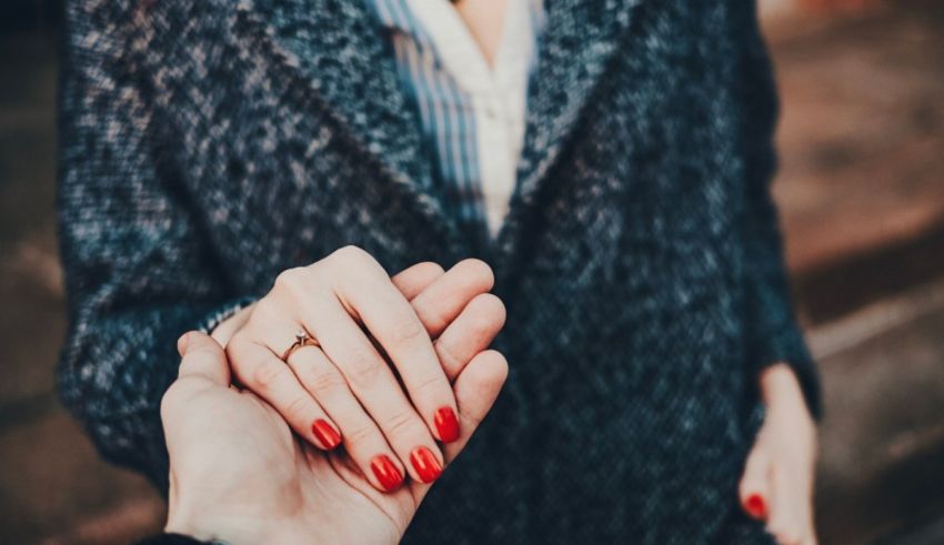 A woman holding a man's hand.