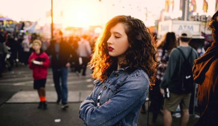 A young woman standing in front of a crowd of people.