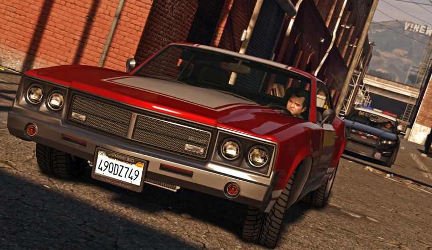 A red car driving down a street in grand theft auto.
