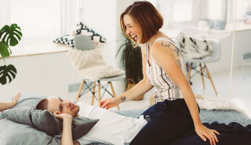 A man and woman are lying on a bed together.