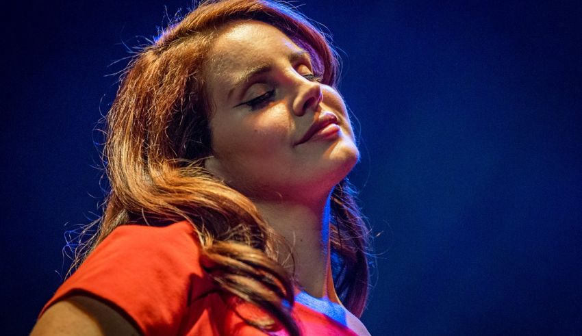 A woman in a red dress is singing into a microphone.