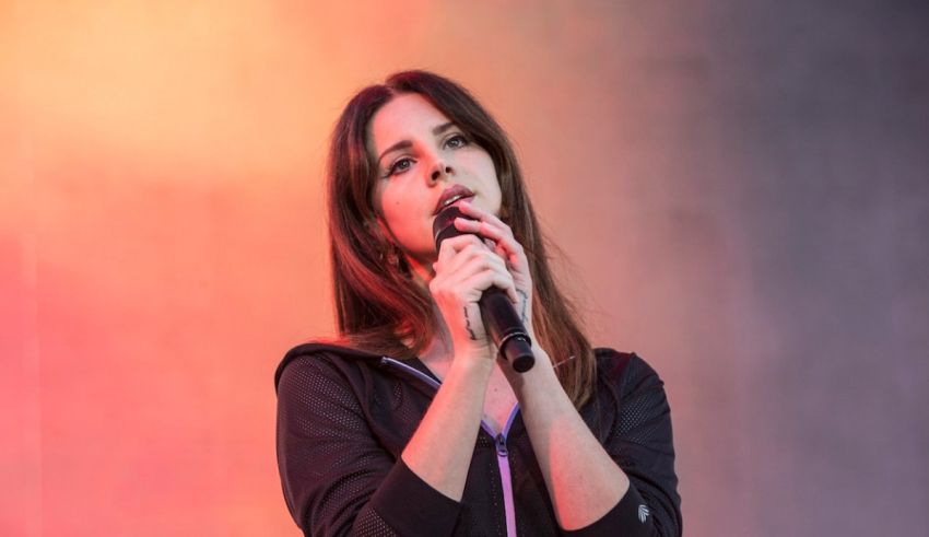 A woman singing into a microphone at a concert.