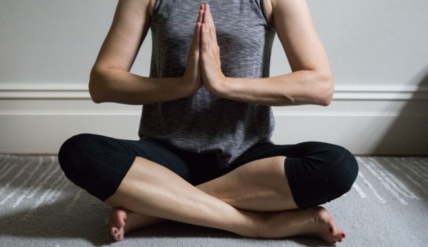 A woman is sitting in a yoga pose.