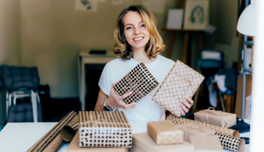 A woman is holding a bunch of cardboard boxes.