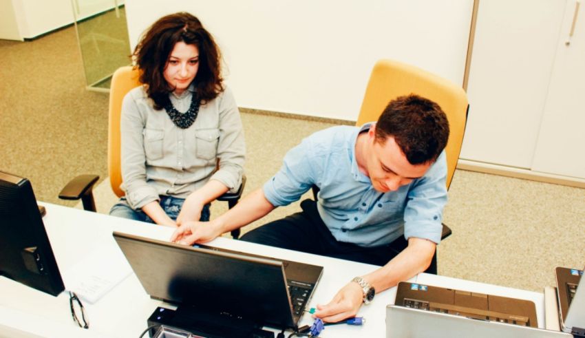 A man and a woman working on a laptop.