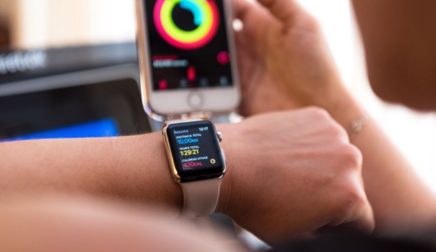 A woman is using an apple watch to monitor her heart rate.