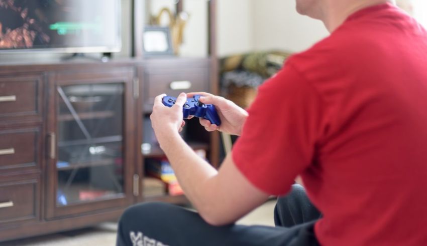 A man holding a blue controller.