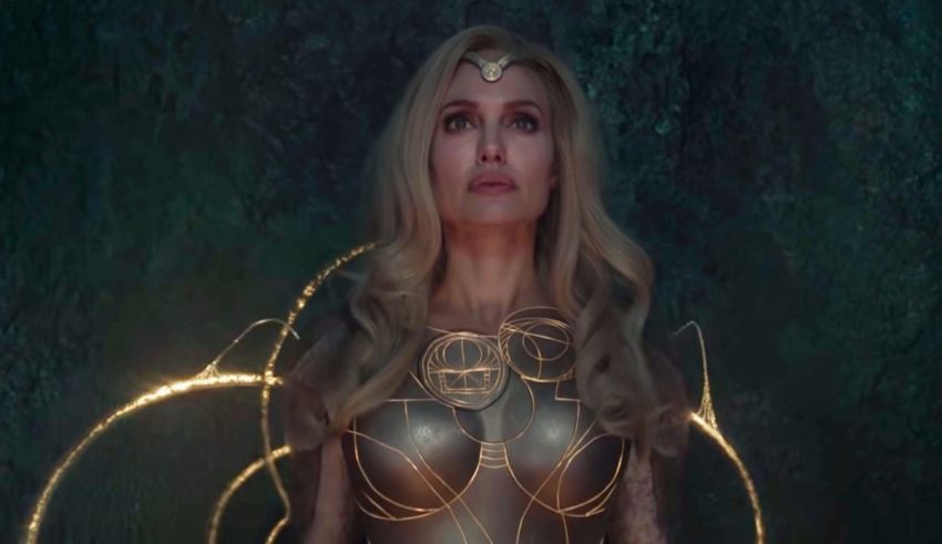 A woman in a golden costume is standing in a dark forest.