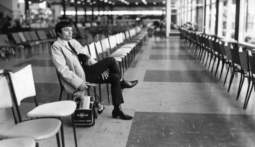 A man sitting on a chair with a suitcase.