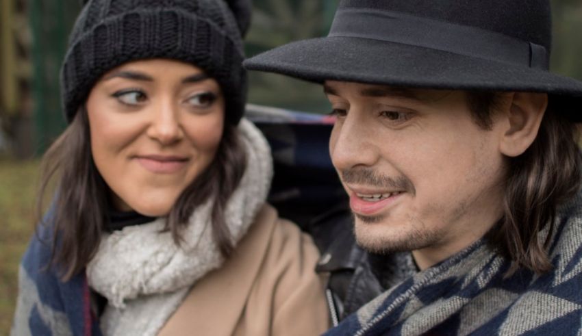A man in a hat and a woman in a scarf.