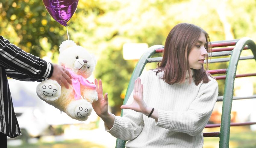 A girl is holding a teddy bear.