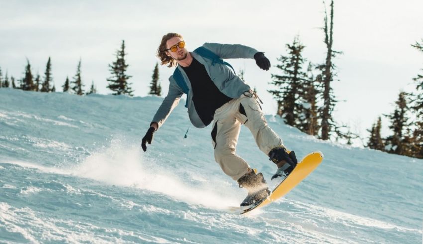 A man riding a snowboard down a snowy slope.