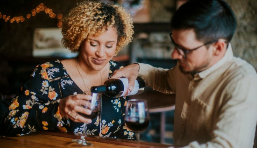 A man pours wine into a woman's glass.