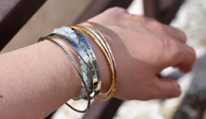 A woman's wrist with several bracelets on it.