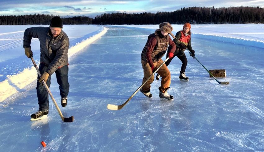 A group of people playing ice hockey on a frozen lake.