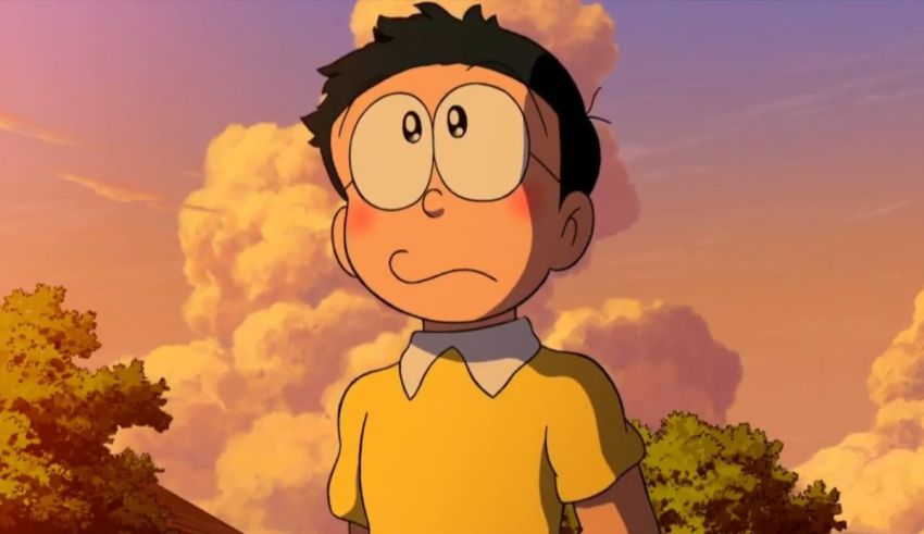 A boy in a yellow shirt is standing in front of a cloudy sky.