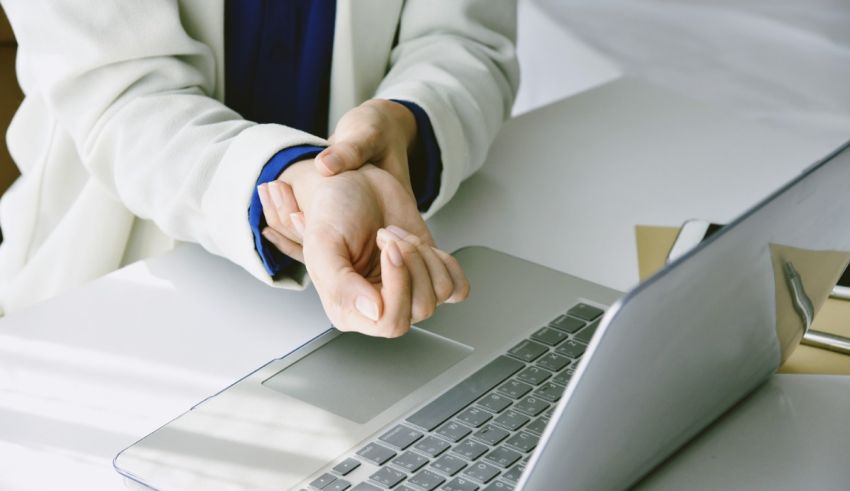 A woman is holding her hand on a laptop.