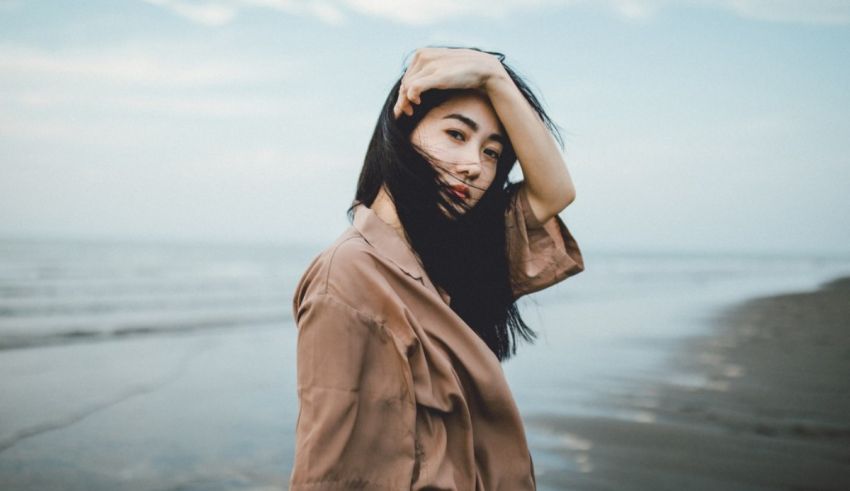 Asian woman posing on the beach.