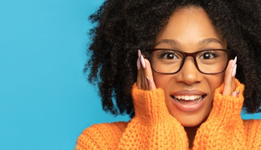 A black woman with glasses and a smile on her face.
