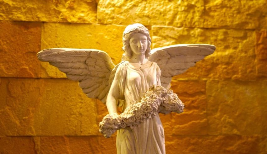 A statue of an angel holding a bouquet of flowers.