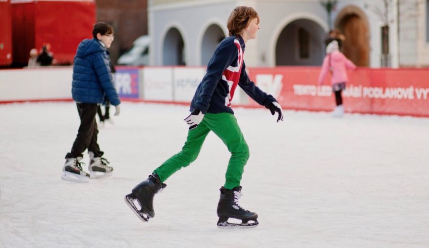 A group of people skating on an ice rink.