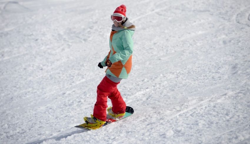 A person riding a snowboard down a snowy slope.