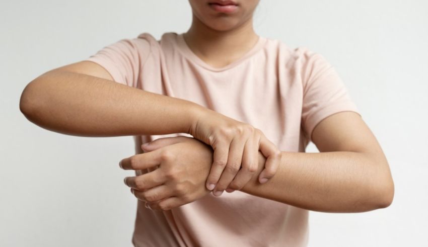 A woman is holding her wrist in pain.