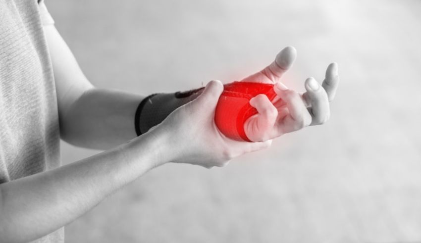 A man is holding a red ball in his hand.