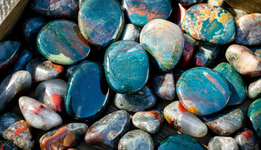 A pile of colorful stones in a wooden box.