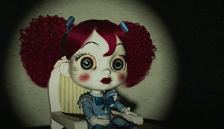 A doll with red hair sitting in a chair.