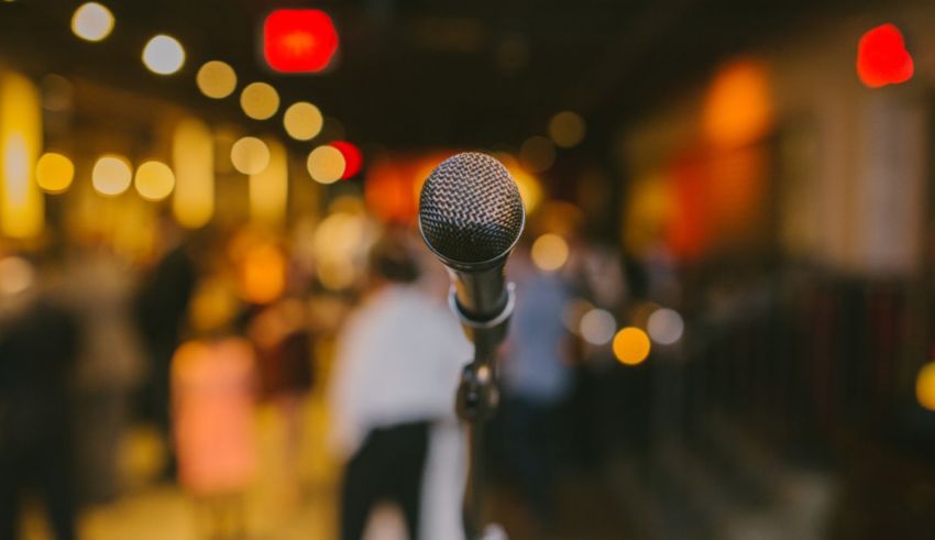 A microphone in front of a crowd of people.