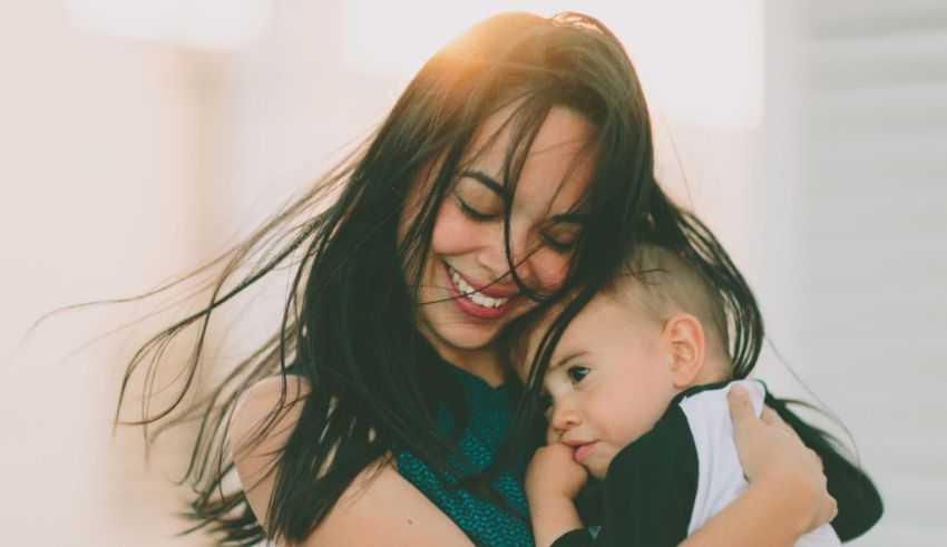 A woman is holding her baby in her arms.