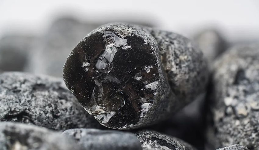 A close up of a pile of black rocks.