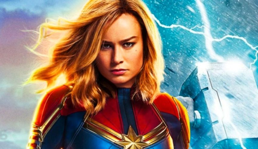 Captain marvel movie poster with a woman standing in front of a lightning storm.