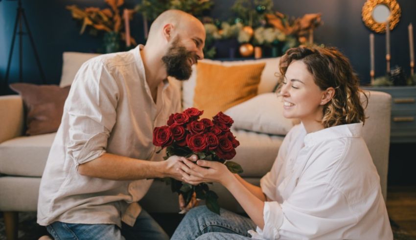 A man is giving a woman a bouquet of roses on valentine's day.