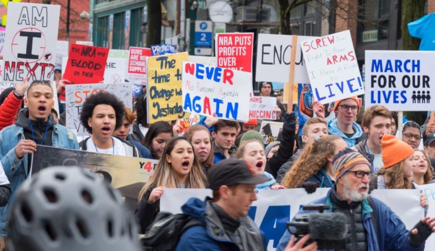 A group of people holding signs in a crowd.