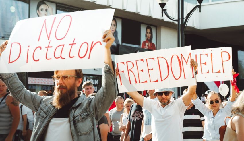 A group of people holding signs that say no dictator freedom help.